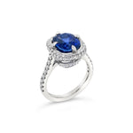 Platinum ring featuring a 4.58ct unheated Ceylon sapphire surrounded by round brilliant cut diamonds totalling 0.42ct in a cluster setting, GSL certified.