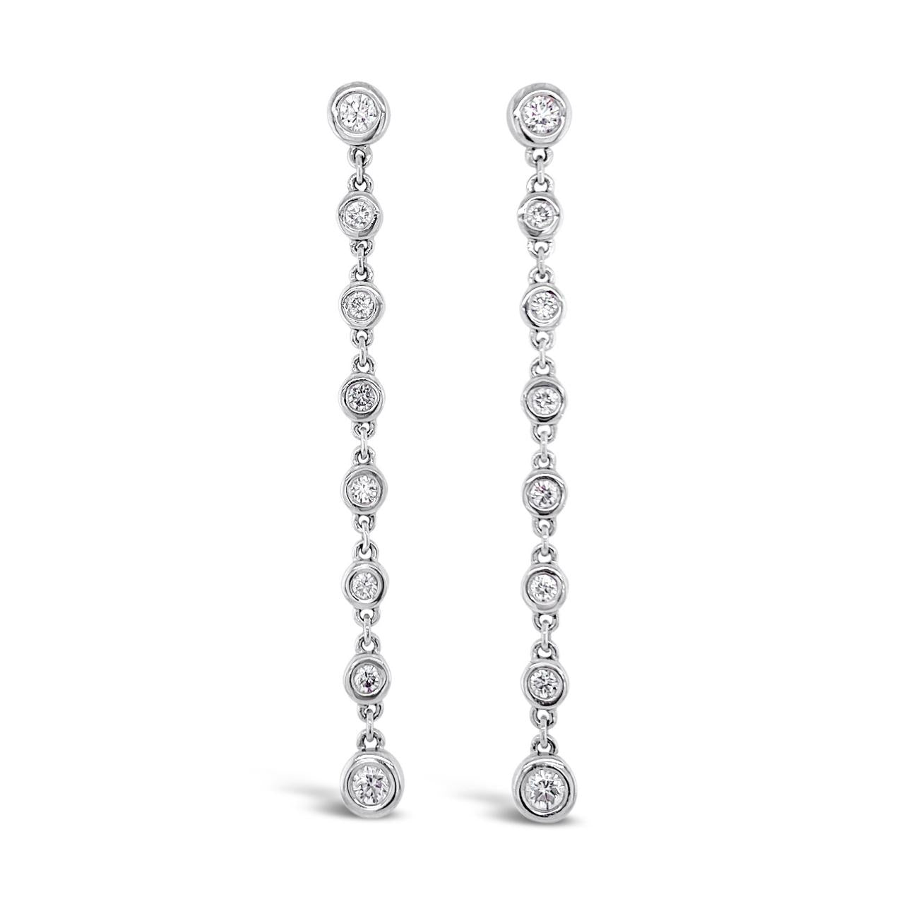 18ct white gold diamond drop earrings with 16 individually bezel-set round brilliant cut diamonds, G–H colour, VS–SI clarity, and post and butterfly fittings.