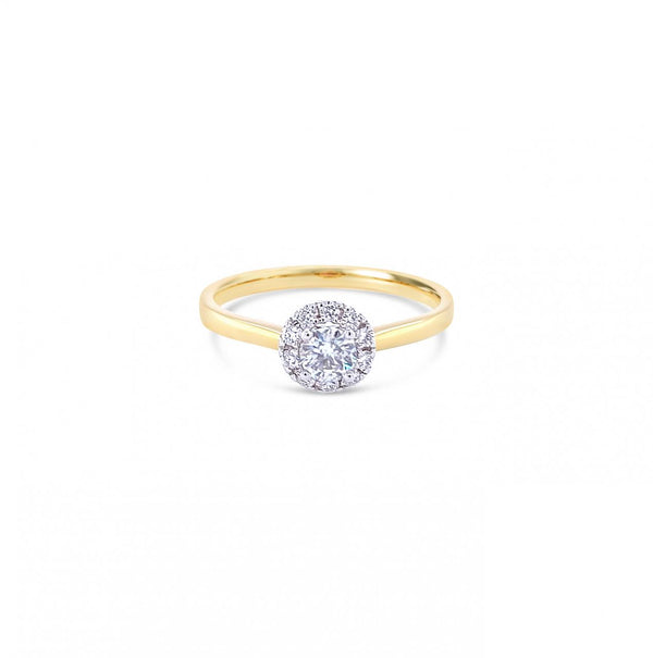 18ct yellow and white gold diamond halo ring featuring a 0.20ct centre diamond with a halo of ten smaller round brilliant cut diamonds.