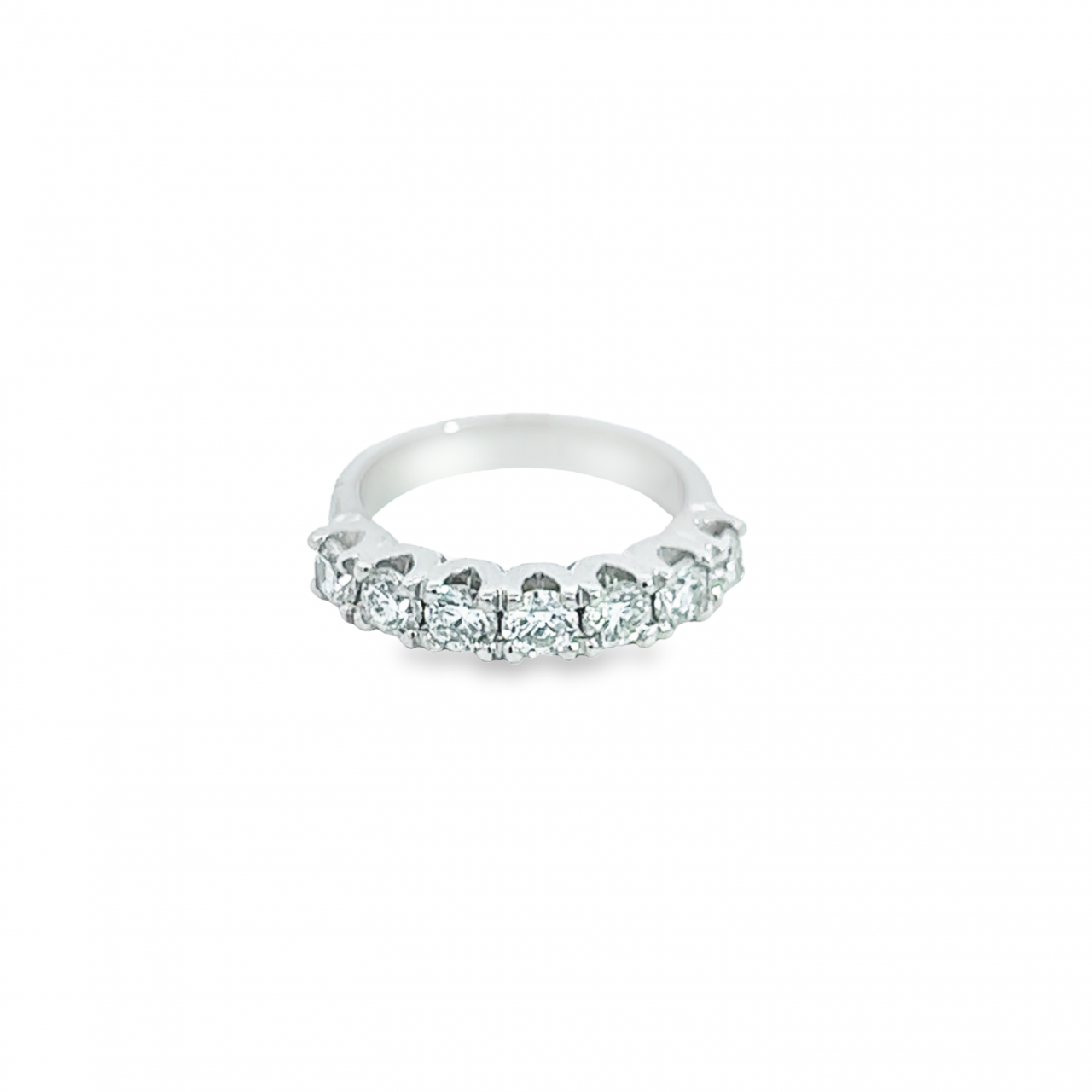 18ct white gold ring featuring seven round brilliant cut diamonds totalling 1.38ct in a straight row shared claw setting with curved undercarriage.