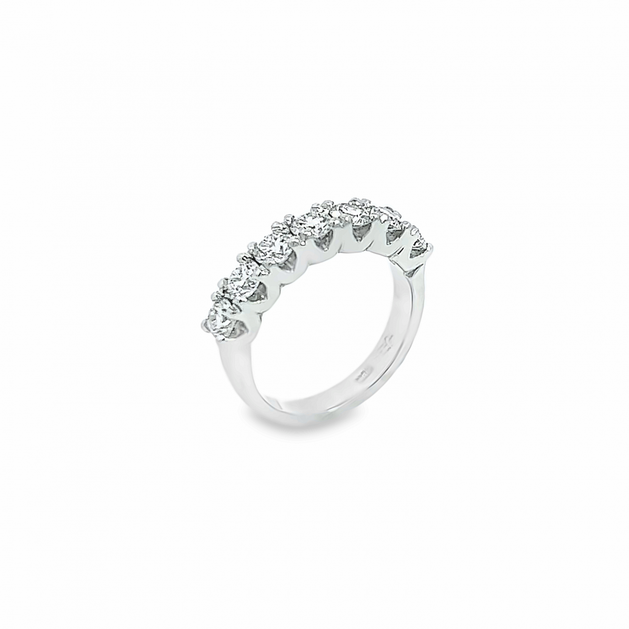 18ct white gold ring featuring seven round brilliant cut diamonds totalling 1.38ct in a straight row shared claw setting with curved undercarriage.