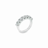 18ct white gold ring featuring seven round brilliant cut diamonds totalling 1.38ct in a straight row shared claw setting with curved undercarriage.