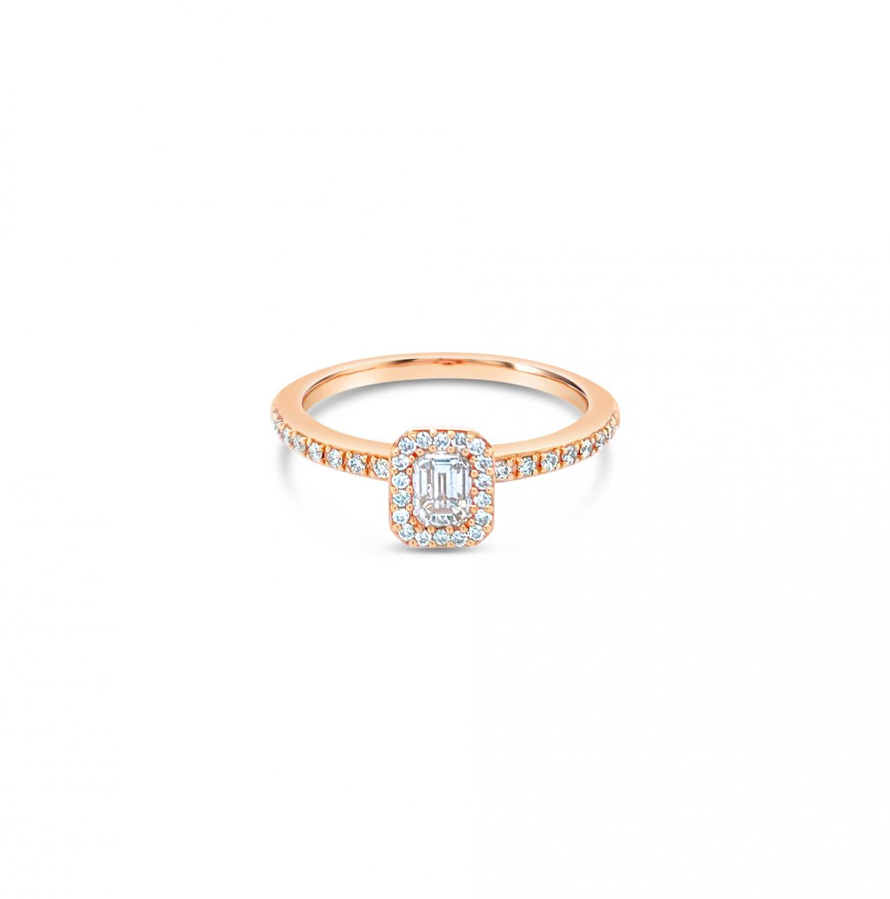 An 18ct rose gold diamond halo ring with an emerald cut central diamond and a halo of round diamonds around it.