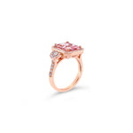 18ct rose gold ring featuring a 2.60ct emerald-cut morganite with dome-shaped diamond clusters and bead-set diamond shoulders.