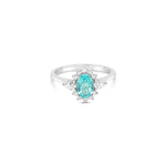 18ct white gold Paraiba tourmaline and diamond ring featuring a 0.67ct oval-cut centre stone, halo surround, and pear-cut diamonds on either side.