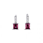 18ct white gold stud earrings featuring round pink tourmalines surrounded by princess cut diamonds, secured with post and butterfly fittings.