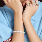 Roberto Coin Love in Verona 18ct white gold diamond bangle with pavé flower motifs and signature hidden rubies inside the clasp.