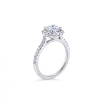 18ct white gold diamond halo ring featuring a 1.01ct round brilliant cut centre diamond with a circular diamond halo and claw-set shoulders.