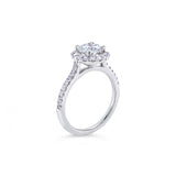 18ct white gold diamond halo ring featuring a 1.01ct round brilliant cut centre diamond with a circular diamond halo and claw-set shoulders.