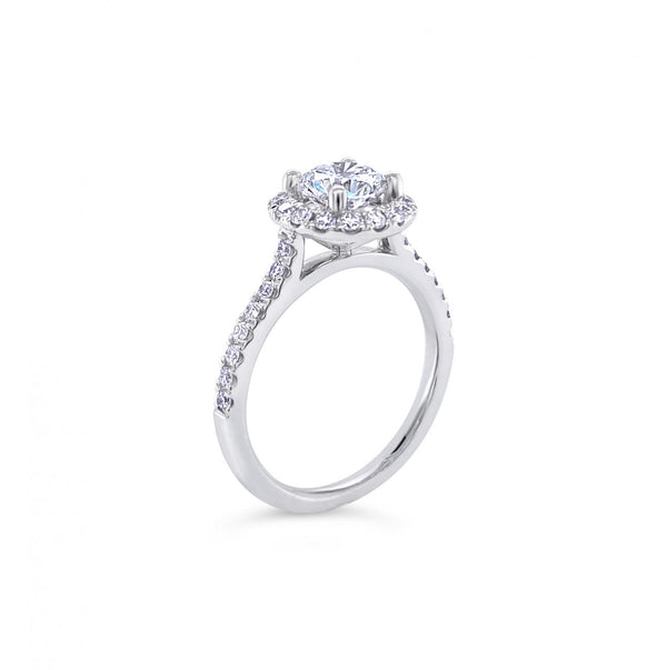 18ct white gold diamond halo ring featuring a 1.01ct round brilliant cut centre diamond with a circular diamond halo and claw-set shoulders.