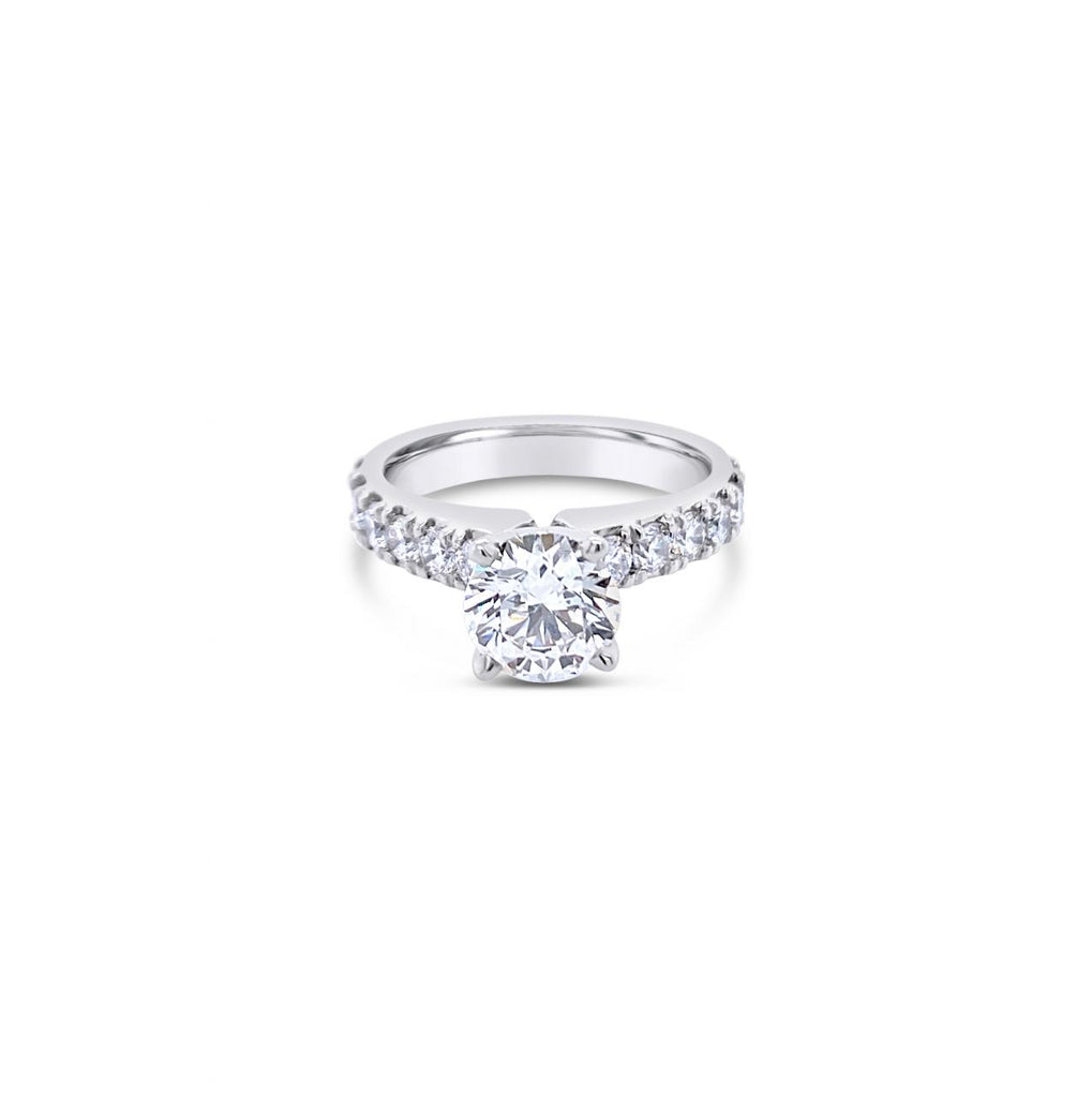 Platinum diamond ring featuring a 1.01ct round brilliant cut centre diamond with sixteen round brilliant cut diamond accents.