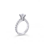 Platinum diamond ring featuring a 1.01ct round brilliant cut centre diamond with sixteen round brilliant cut diamond accents.