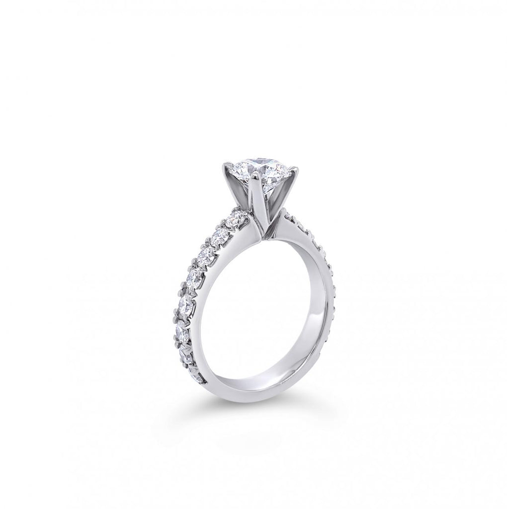 Platinum diamond ring featuring a 1.01ct round brilliant cut centre diamond with sixteen round brilliant cut diamond accents.