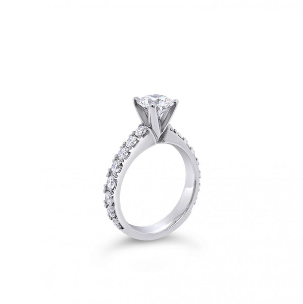 Platinum diamond ring featuring a 1.01ct round brilliant cut centre diamond with sixteen round brilliant cut diamond accents.