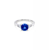18ct white gold ring featuring a 1.32ct round-cut sapphire with pear-cut diamond accents totalling 0.25ct in elegant claw settings.