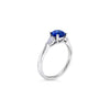 18ct white gold ring featuring a 1.32ct round-cut sapphire with pear-cut diamond accents totalling 0.25ct in elegant claw settings.