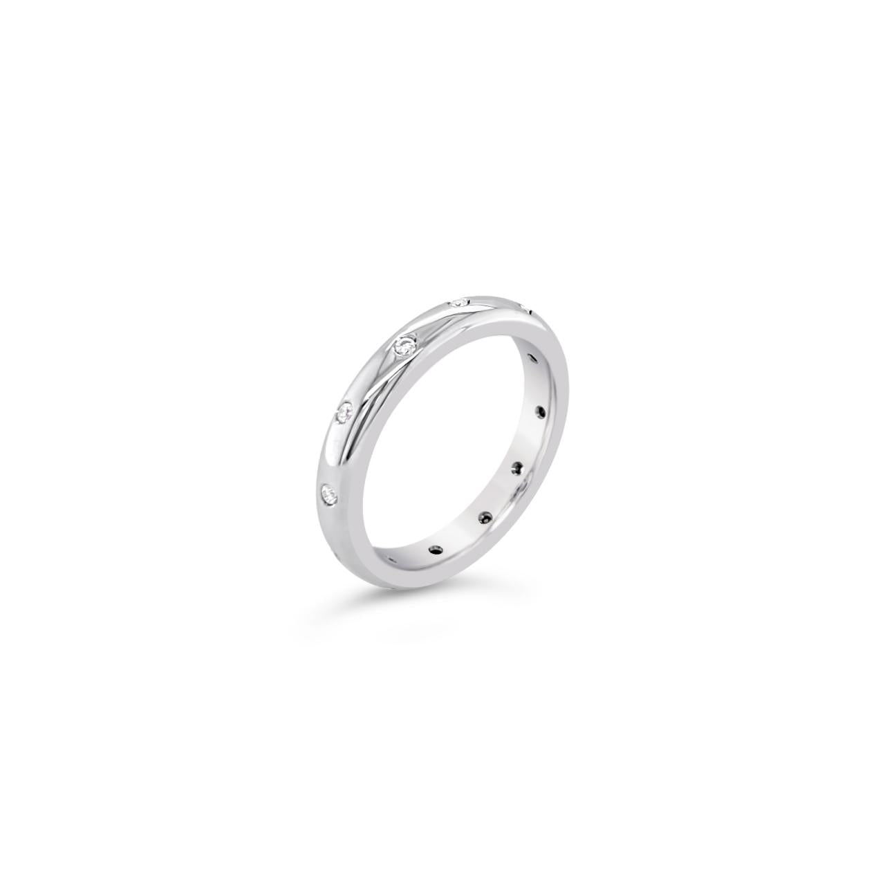 18ct white gold wedding ring featuring twelve round brilliant cut diamonds totalling 0.12ct, scatter-set in a high half-round band.