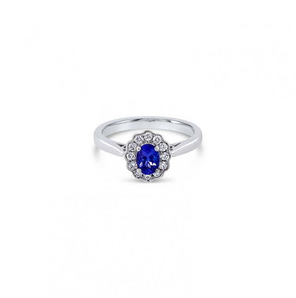 18ct white gold ring featuring a 0.45ct oval cut tanzanite surrounded by twelve round brilliant cut diamonds in an elegant oval cluster design.
