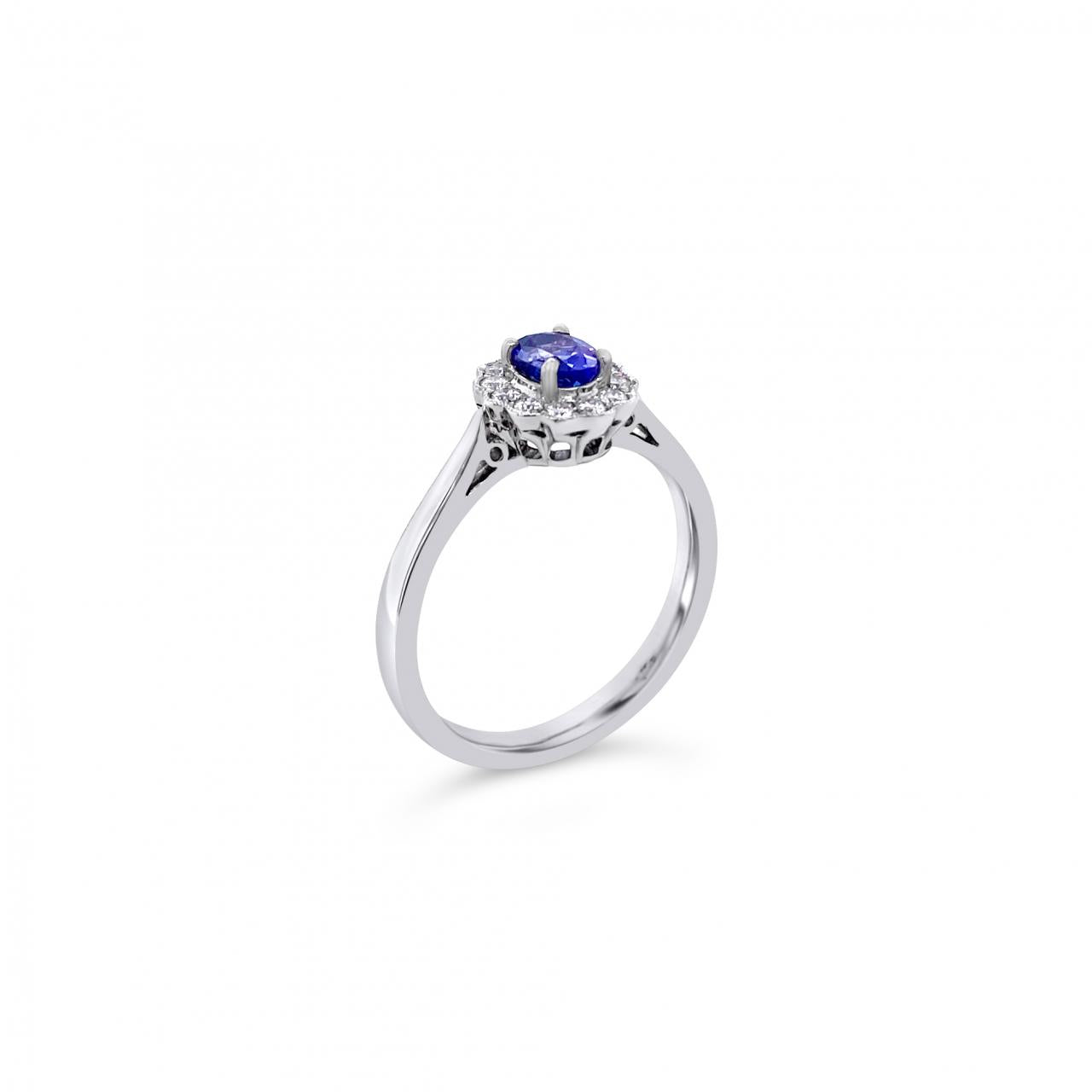 18ct white gold ring featuring a 0.45ct oval cut tanzanite surrounded by twelve round brilliant cut diamonds in an elegant oval cluster design.
