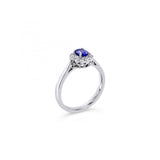 18ct white gold ring featuring a 0.45ct oval cut tanzanite surrounded by twelve round brilliant cut diamonds in an elegant oval cluster design.