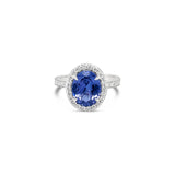 18ct white gold ring featuring a 2.30ct oval cut tanzanite surrounded by a halo of 34 round brilliant cut diamonds with diamond-set shoulders.
