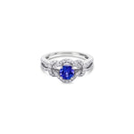 18ct white gold ring featuring a 0.52ct tanzanite surrounded by 64 round brilliant cut diamonds in an elegant claw-set design.