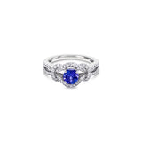 18ct white gold ring featuring a 0.52ct tanzanite surrounded by 64 round brilliant cut diamonds in an elegant claw-set design.