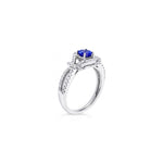 18ct white gold ring featuring a 0.52ct tanzanite surrounded by 64 round brilliant cut diamonds in an elegant claw-set design.