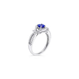 18ct white gold ring featuring a 0.52ct tanzanite surrounded by 64 round brilliant cut diamonds in an elegant claw-set design.