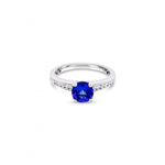 18ct white gold ring with round tanzanite and channel-set diamond shoulders.